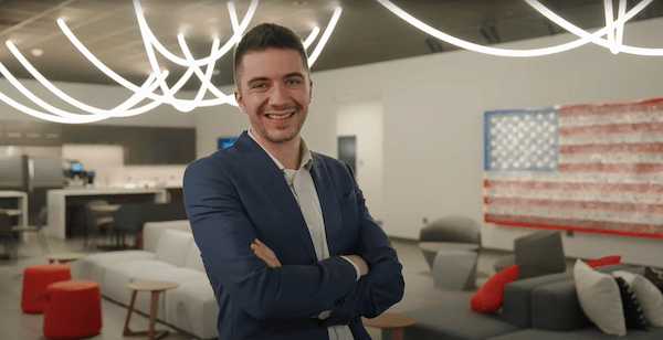 An individual with arms crossed, smiling confidently at the camera, representing success in design and engineering services